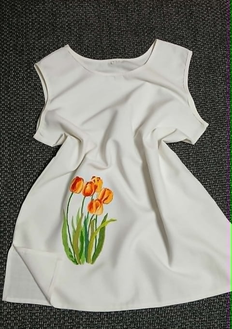 White sleeveless dress with cold-shoulder design and hand-painted orange tulip flowers on the front