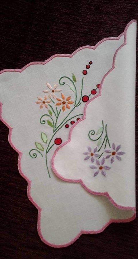 Embroidered handkerchief with pink scalloped border featuring orange and purple flowers with red berries and green stems