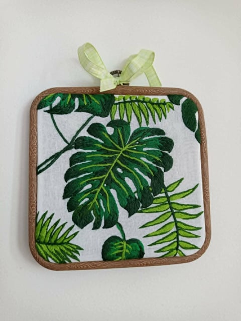 Wooden planter with fabric botanical leaf design and pale green decorative leaves on top