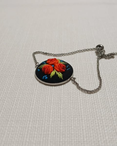Silver chain necklace with oval pendant featuring red strawberry and blueberries on black enamel background