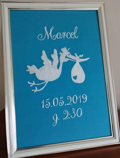 Framed turquoise birth announcement for Marcel showing a stork silhouette with date 15.05.2019 and time 9.2.30