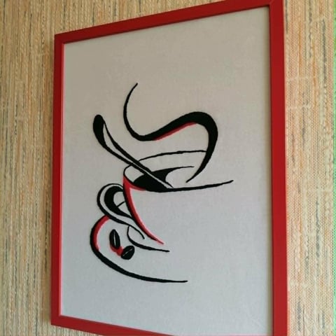 Framed abstract line drawing with black and red curved lines on white background, hanging on wooden wall