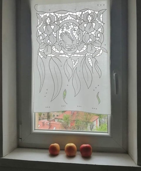 Hand-drawn illustration of ornate mandala design with hanging vines displayed in window with three apples on sill